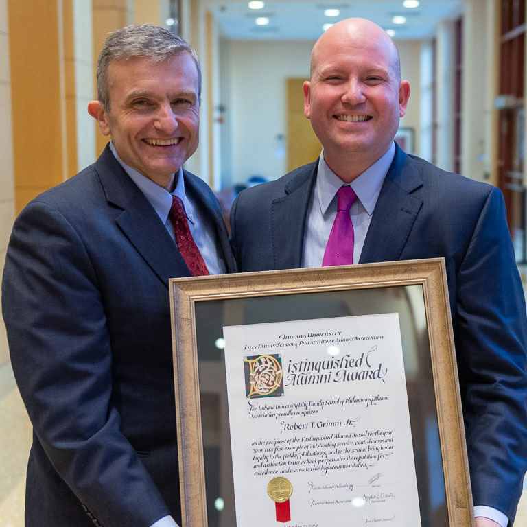 Bob Grimm receiving Distinguished Alumni Award with Amir Pasic