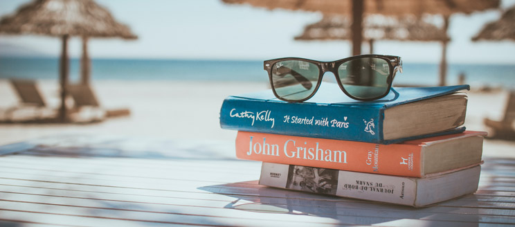 books and sunglasses near beach